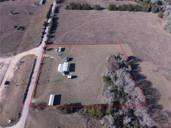 an aerial view of a house with a yard