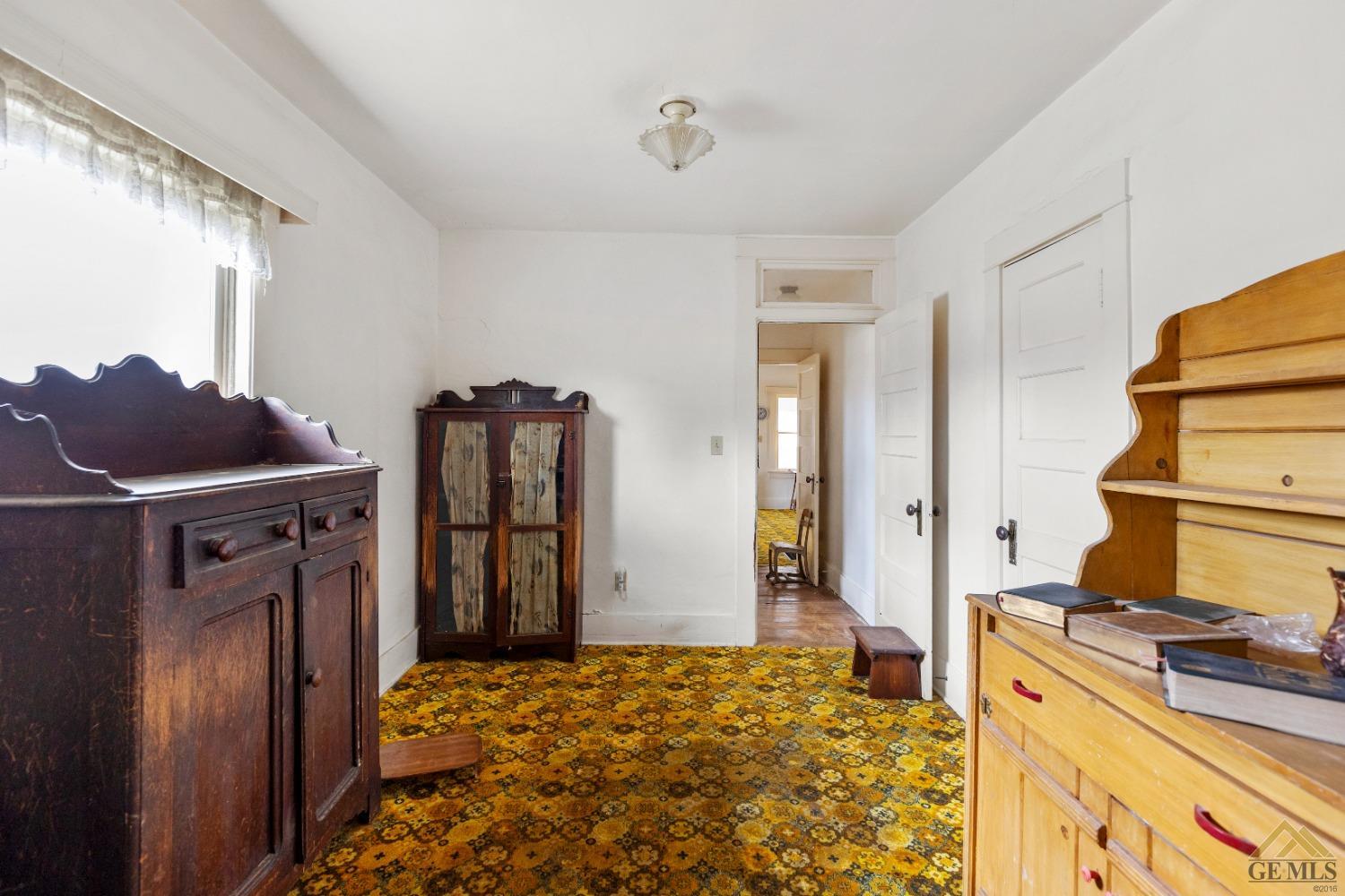 Undisclosed Address Tehachapi, CA 93561 - Photo 13 of 22 a bedroom with a bed and wooden cabinets