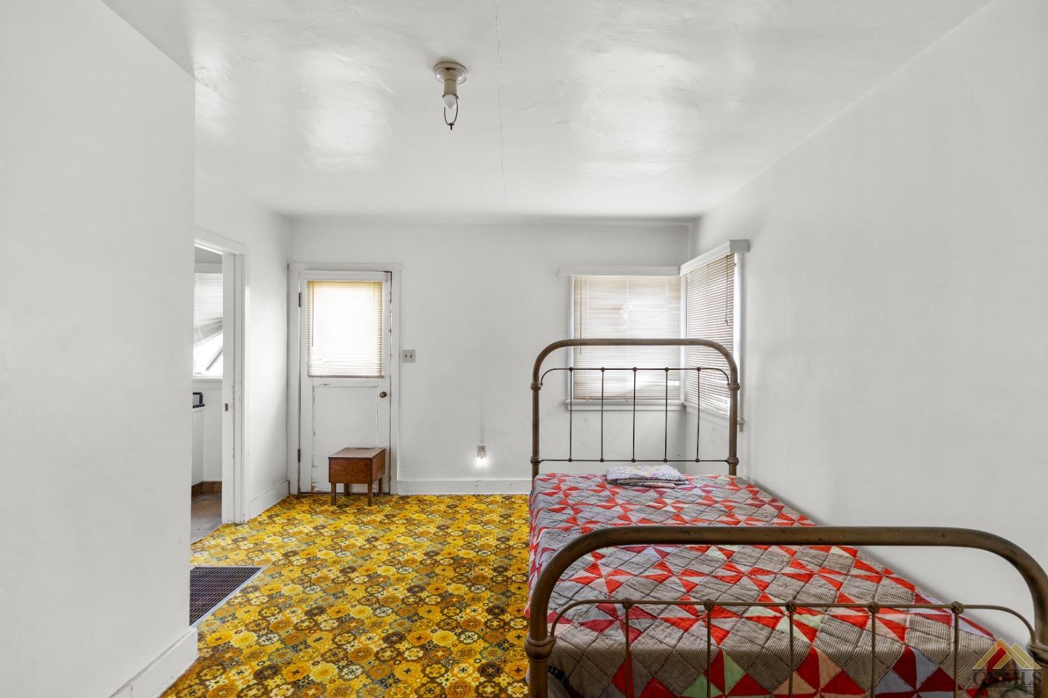 Undisclosed Address Tehachapi, CA 93561 - Photo 14 of 22 a bedroom with a bed and a chandelier