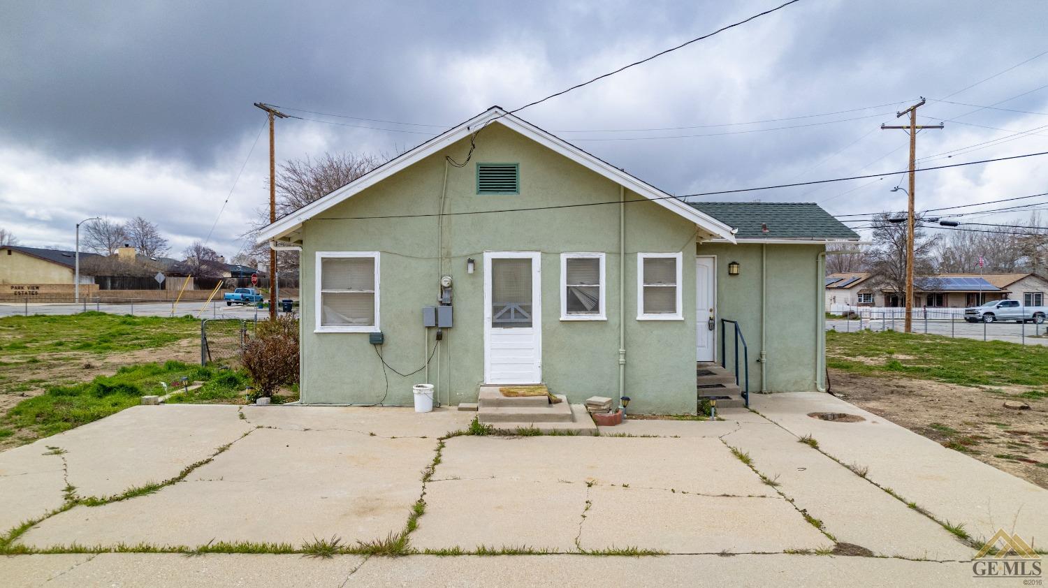 Undisclosed Address Tehachapi, CA 93561 - Photo 22 of 22 a front view of a house with a yard and garage