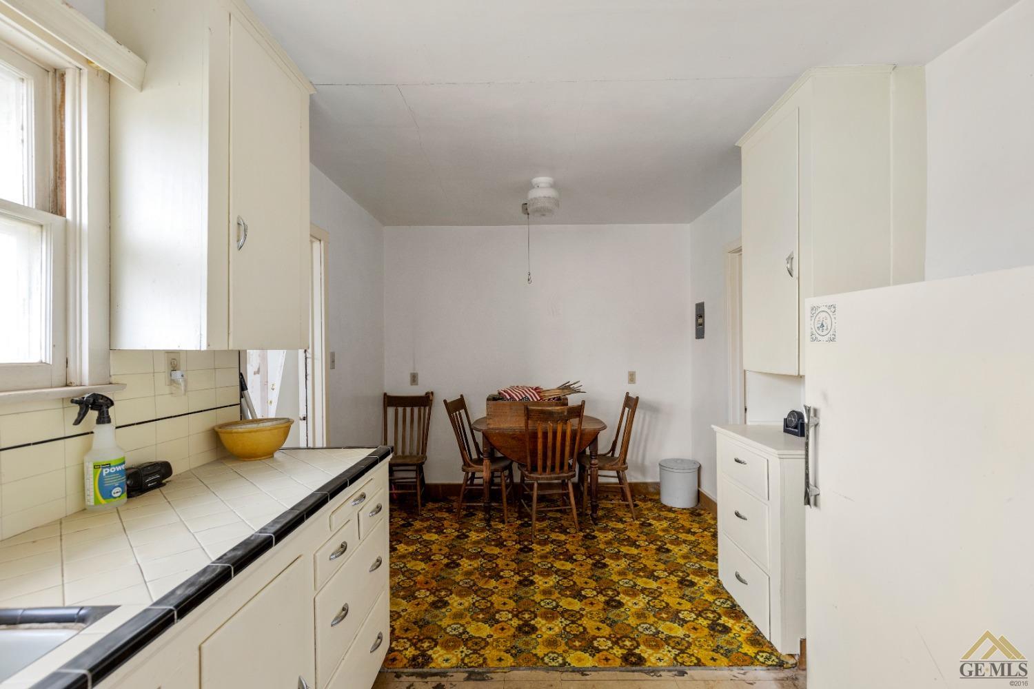Undisclosed Address Tehachapi, CA 93561 - Photo 4 of 22 a kitchen with a sink and wooden cabinets