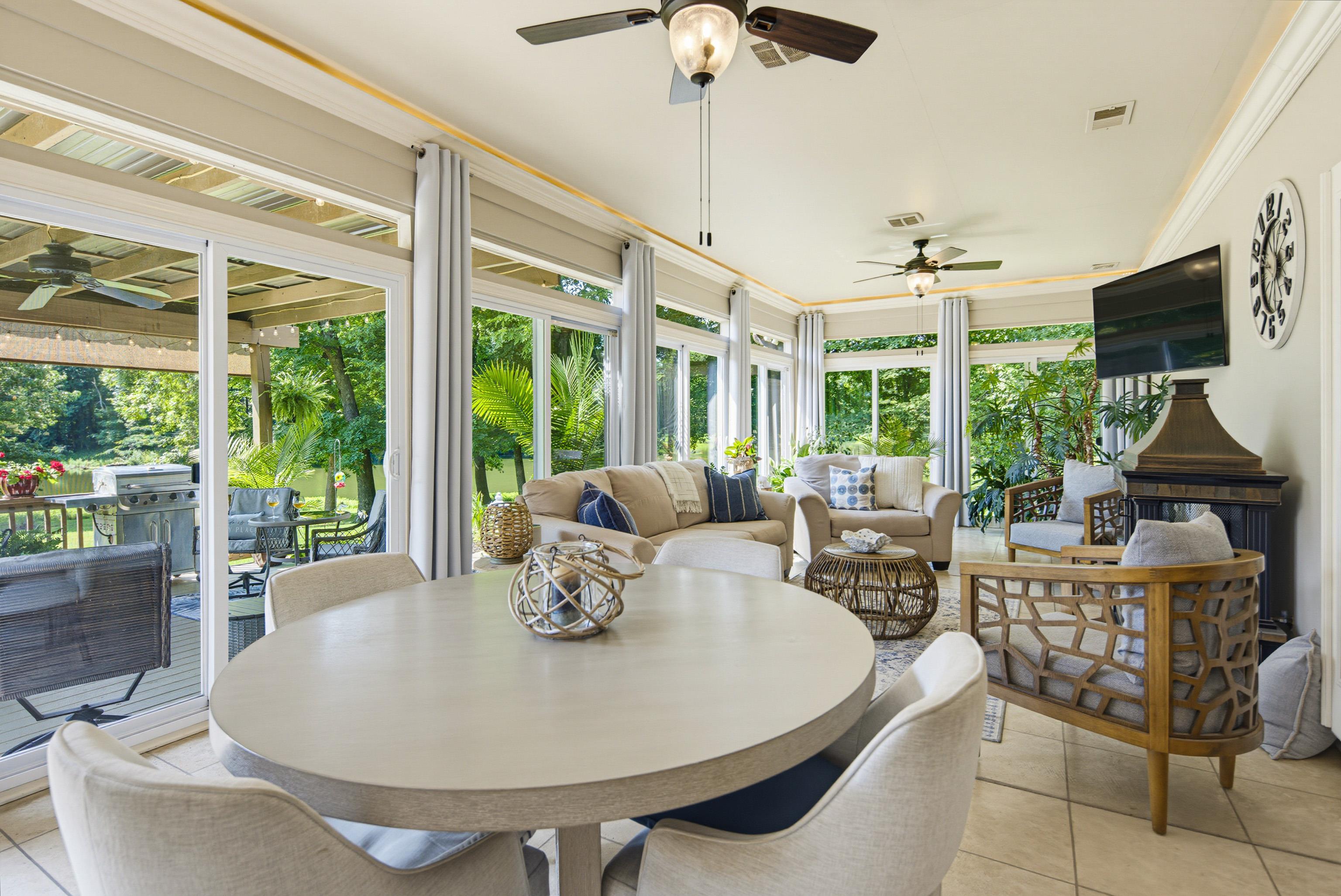 243 Hayes Road Munford, TN 38058 - Photo 5 of 25 Florida-Style sunroom encased in sliding glass doors overlooking lake