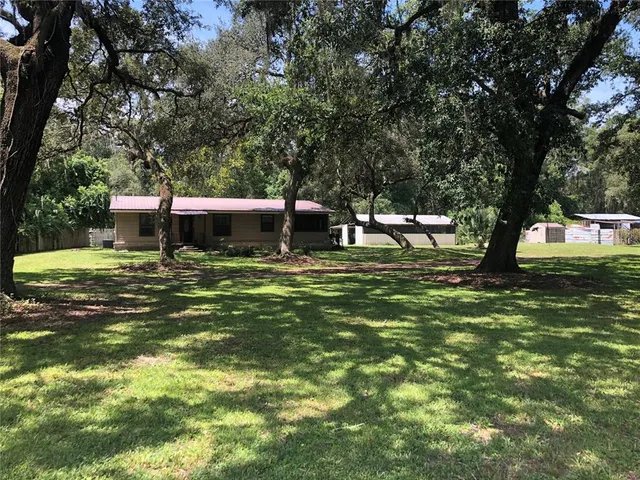 a view of a house with a yard porch and sitting area