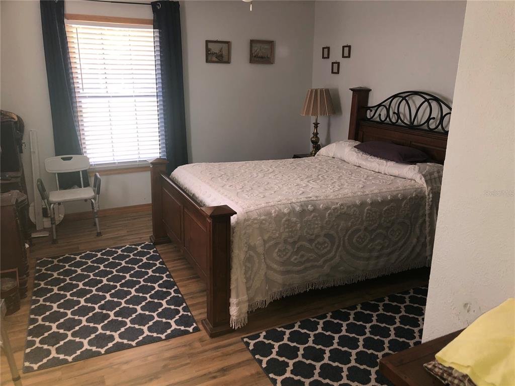 136 Commercial Street Coleman, FL 32163 - Photo 8 of 14 a bedroom with a bed and a window