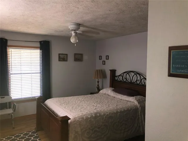 a bedroom with a bed and a table in it
