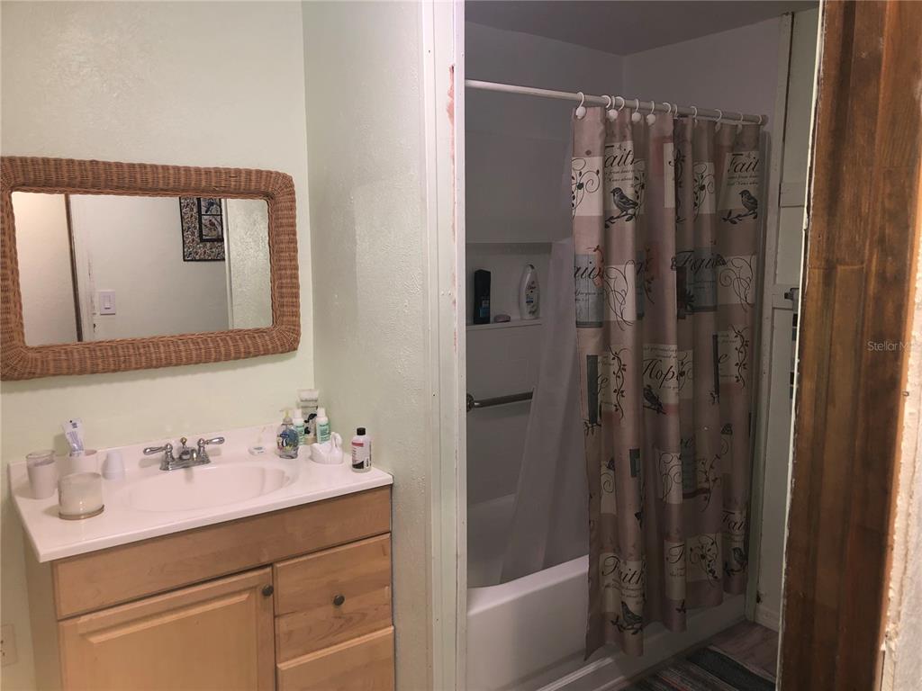 136 Commercial Street Coleman, FL 32163 - Photo 10 of 14 a bathroom with a shower sink and mirror