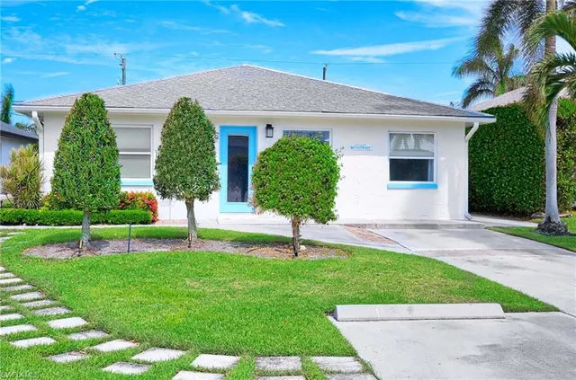 a house with green field in front of it