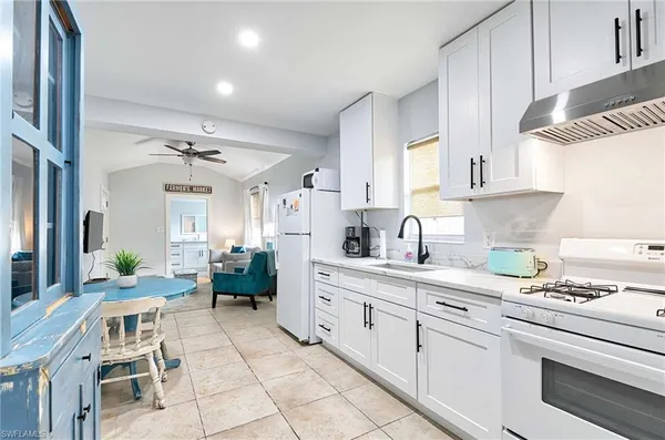 a kitchen with a sink cabinets and window