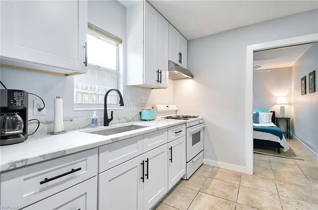 a kitchen with a sink and cabinets