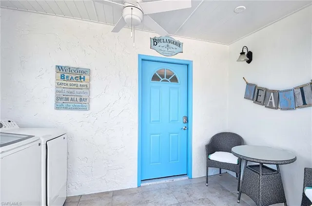 a view of a hallway with furniture and a chandelier