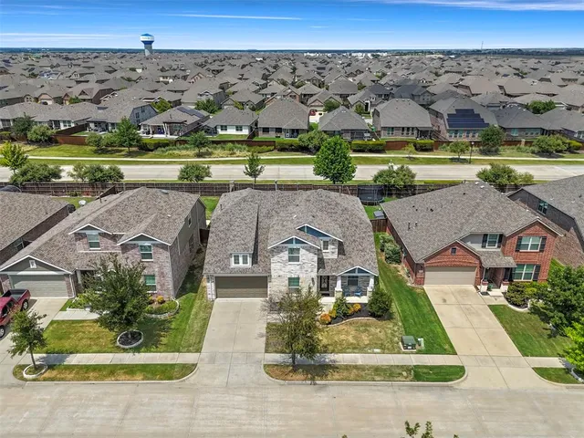 an aerial view of a house with a yard basket ball court and outdoor seating