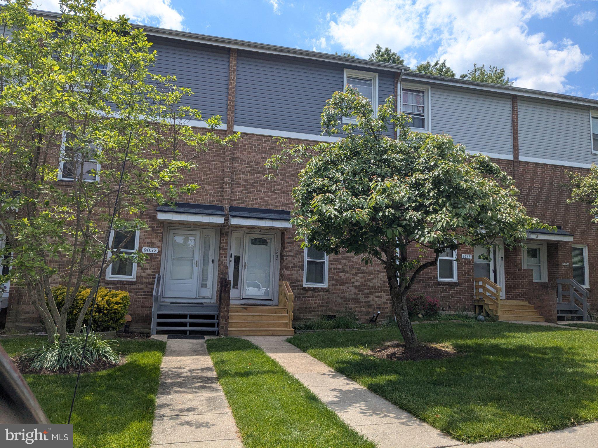 9054 Canterbury Riding, Unit 147 Laurel, MD 20723 - Photo 2 of 3 a front view of a house with a garden