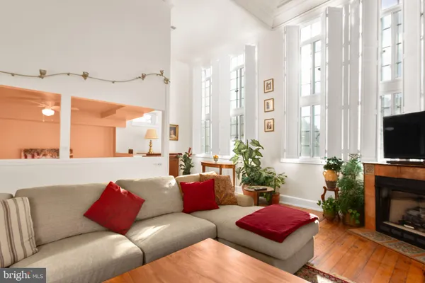 a living room with furniture fireplace and a large window