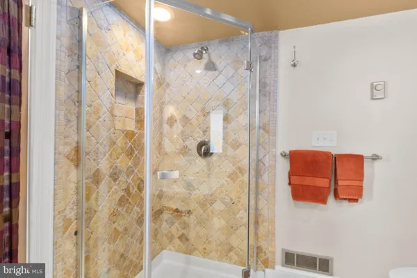 a bathroom with a shower and a mirror