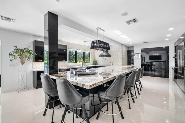 a kitchen with granite countertop a refrigerator and a sink