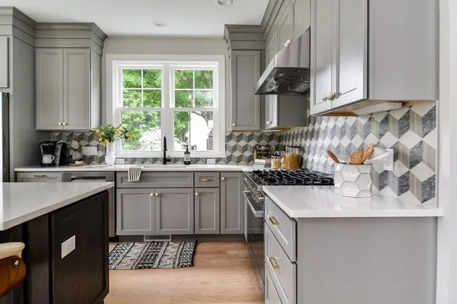 a kitchen with a sink stove and cabinets