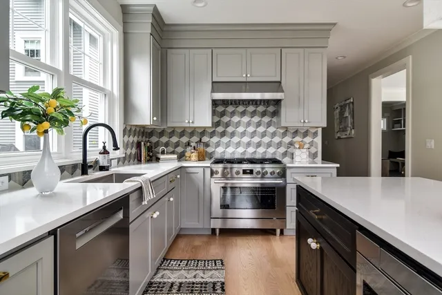 a kitchen with a sink stove and cabinets