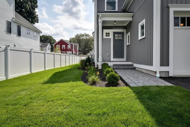 a view of a house with a yard and plants