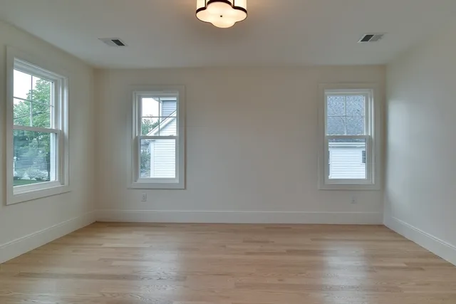 a kitchen with a white cabinets and a window