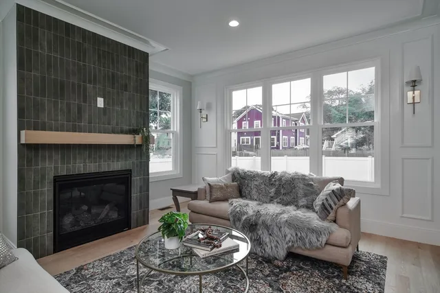 a living room with furniture a window and a fireplace