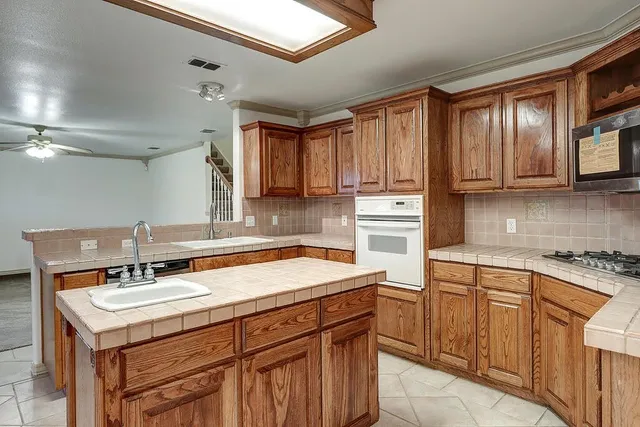 a kitchen with a sink cabinets and appliances