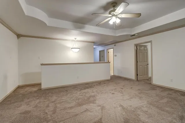 en empty room with windows and fan