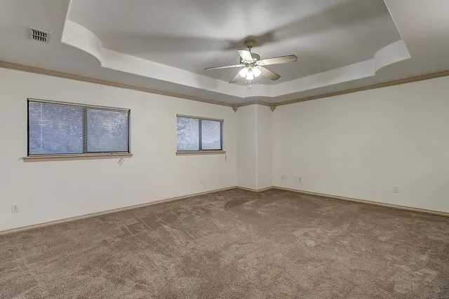a view of an empty room with a fan