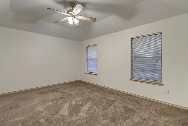 a view of an empty room with a fan