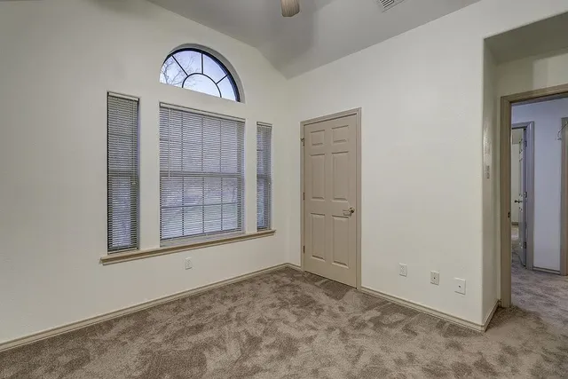 an empty room with windows and closet