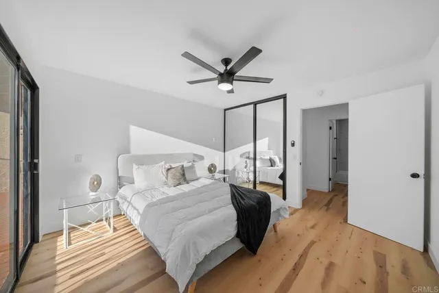 a spacious bedroom with a bed and ceiling fan