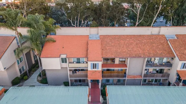 aerial view of a house with roof deck and seating space