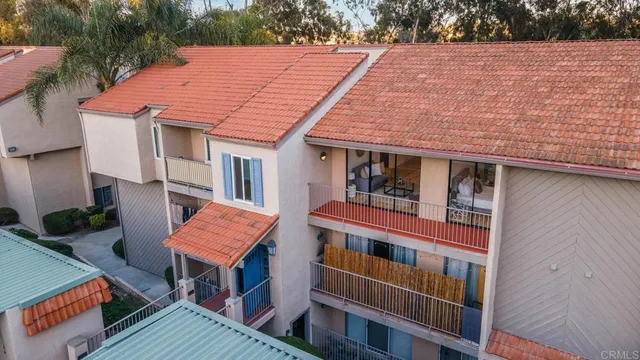 a view of house with a yard and wooden fence