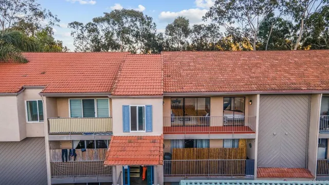 an aerial view of a balcony with outdoor seating