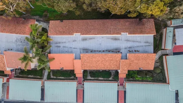 a view of a tennis ground with a table and chairs