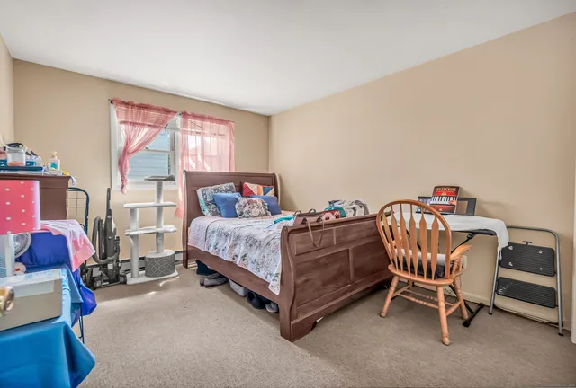 a bedroom with a bed and a chair