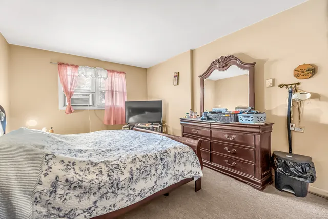 a bedroom with a bed and a dresser