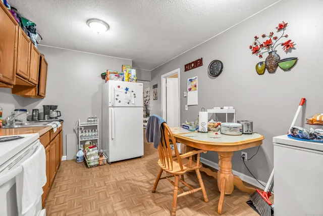 a kitchen with a dining table and appliances