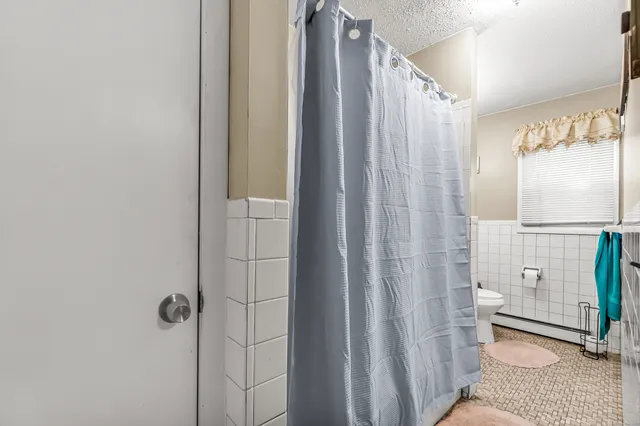 a bathroom with a shower and a toilet