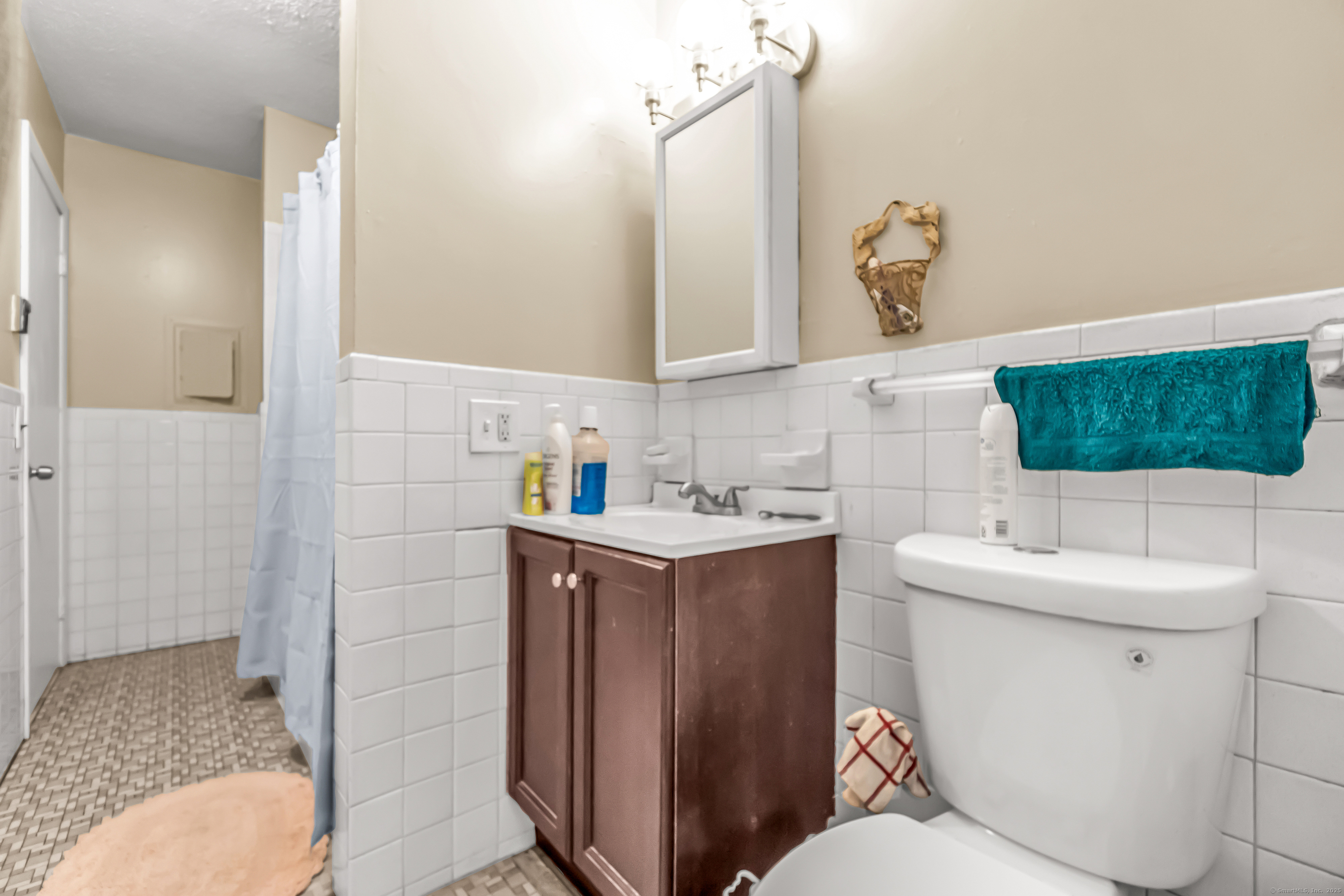 161 West Spring Street, Unit C1 West Haven, CT 06516 - Photo 10 of 14 a bathroom with a sink toilet and mirror