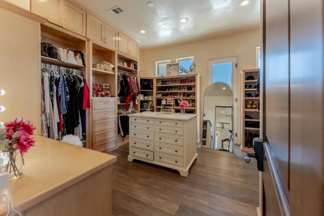 a view of a porch with chairs and potted plants
