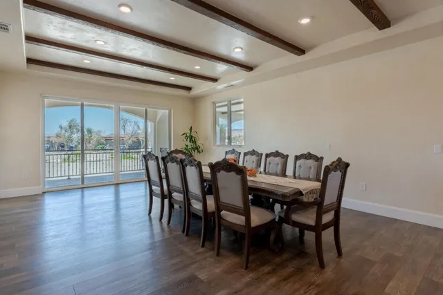 a kitchen with stainless steel appliances kitchen island a table and chairs in it
