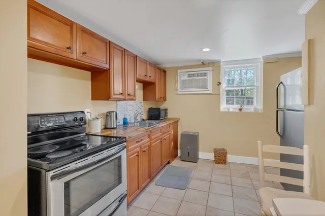 a kitchen with stainless steel appliances granite countertop a stove a sink and a refrigerator