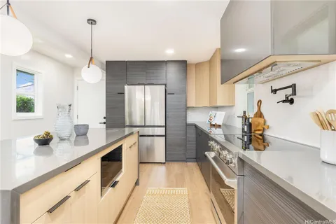 a kitchen with a sink appliances and cabinets