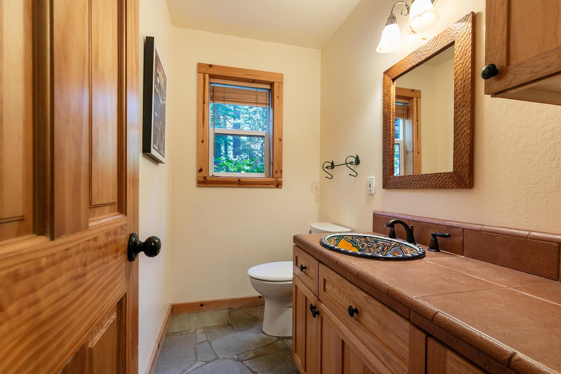 11325 Thelin Drive Truckee, CA 96161 - Photo 12 of 21 a bathroom with a sink a toilet and mirror