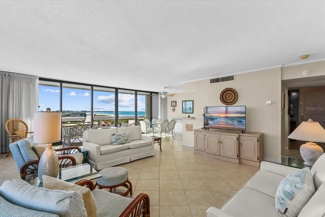 a dining room with furniture and large windows