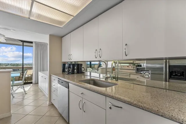 a bedroom with a bed a mirror on dresser and a window