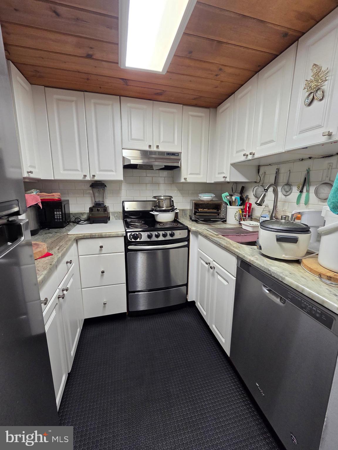 1010 Race Street, Unit 6LM Philadelphia, PA 19107 - Photo 11 of 25 a kitchen with granite countertop a sink stainless steel appliances and cabinets