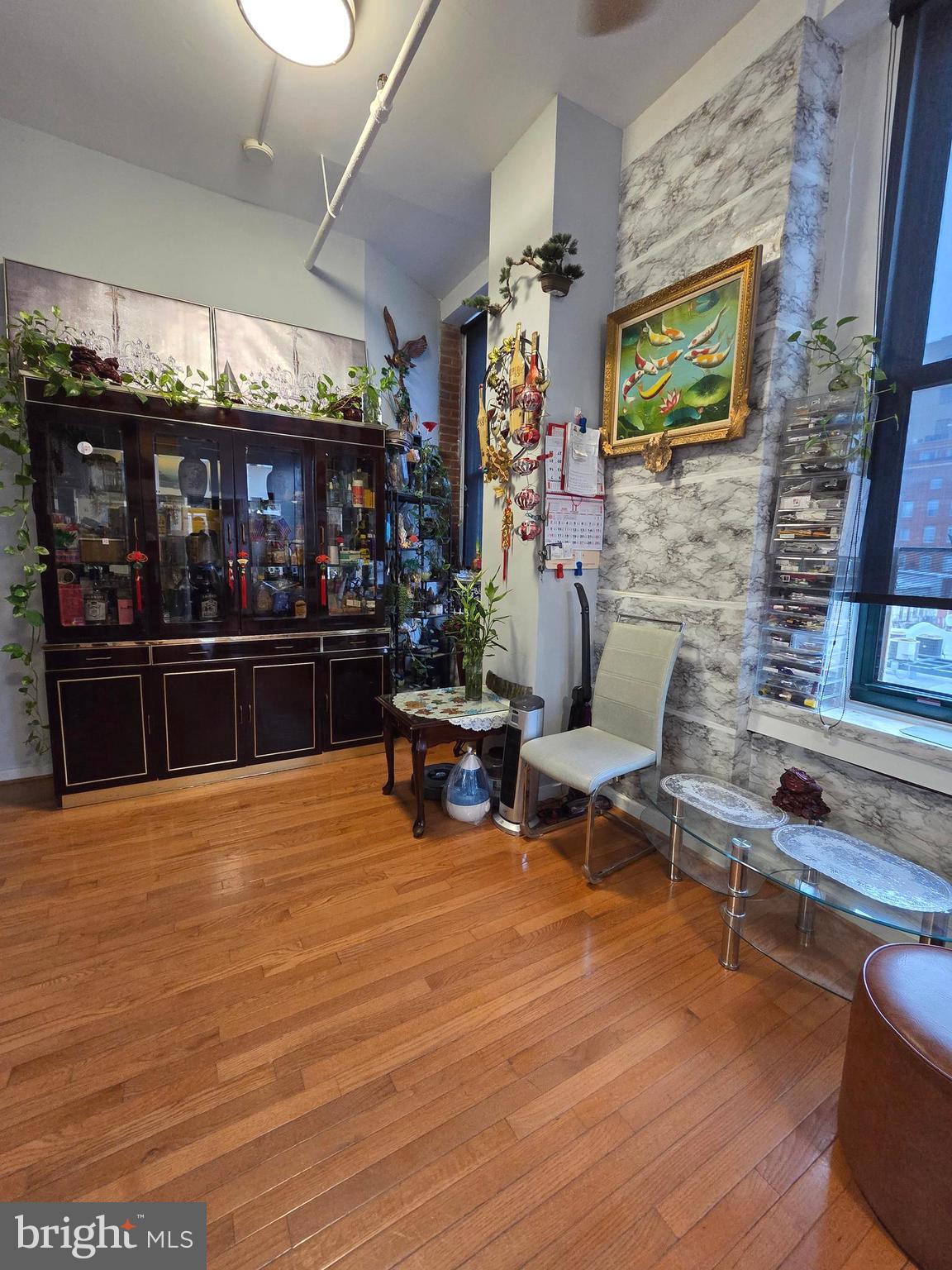 1010 Race Street, Unit 6LM Philadelphia, PA 19107 - Photo 15 of 25 a living room with furniture a fireplace and a flat screen tv