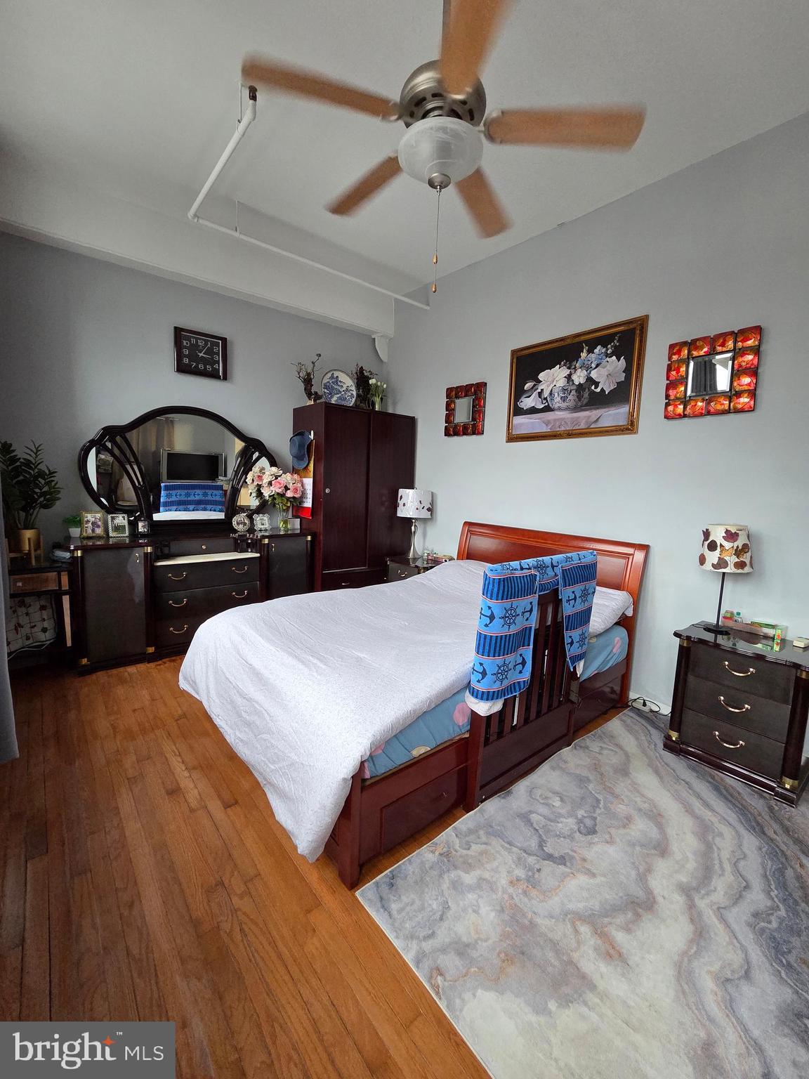 1010 Race Street, Unit 6LM Philadelphia, PA 19107 - Photo 20 of 25 a bedroom with bed and a chandelier