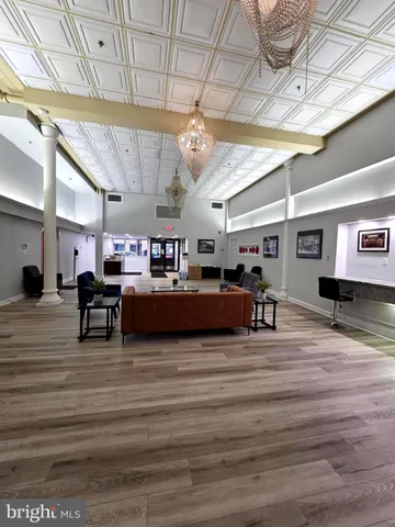 a living room with lots of furniture and a chandelier